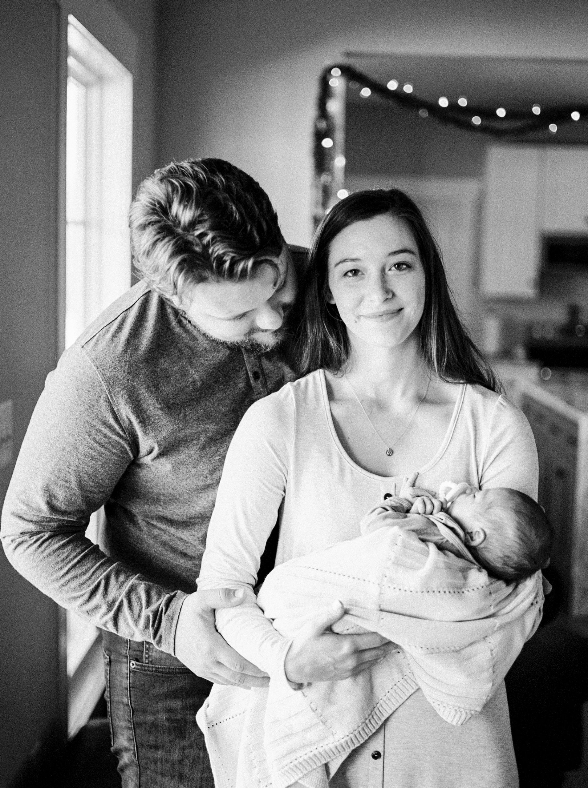 lifestyle newborn portraits with parents holding baby boy in Tennessee
