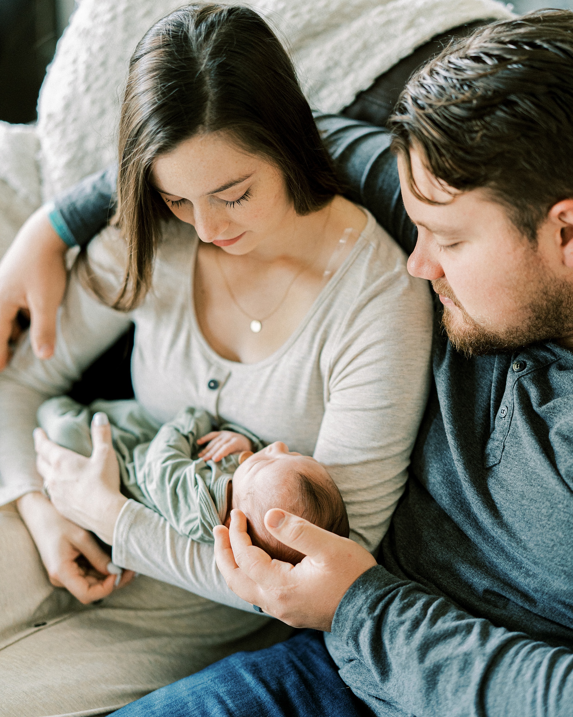 new parents look at baby during TN newborn photos at home