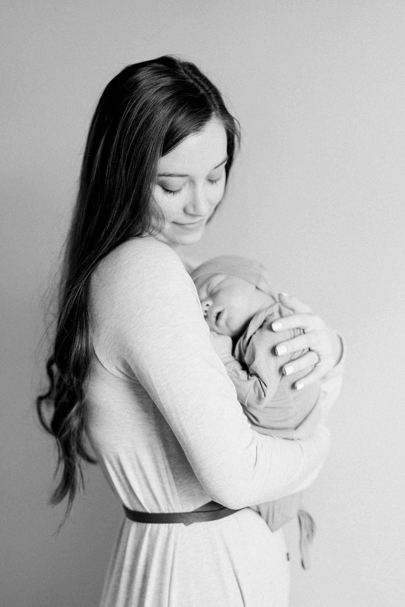lifestyle newborn portraits of mom holding newborn baby boy in Tennessee