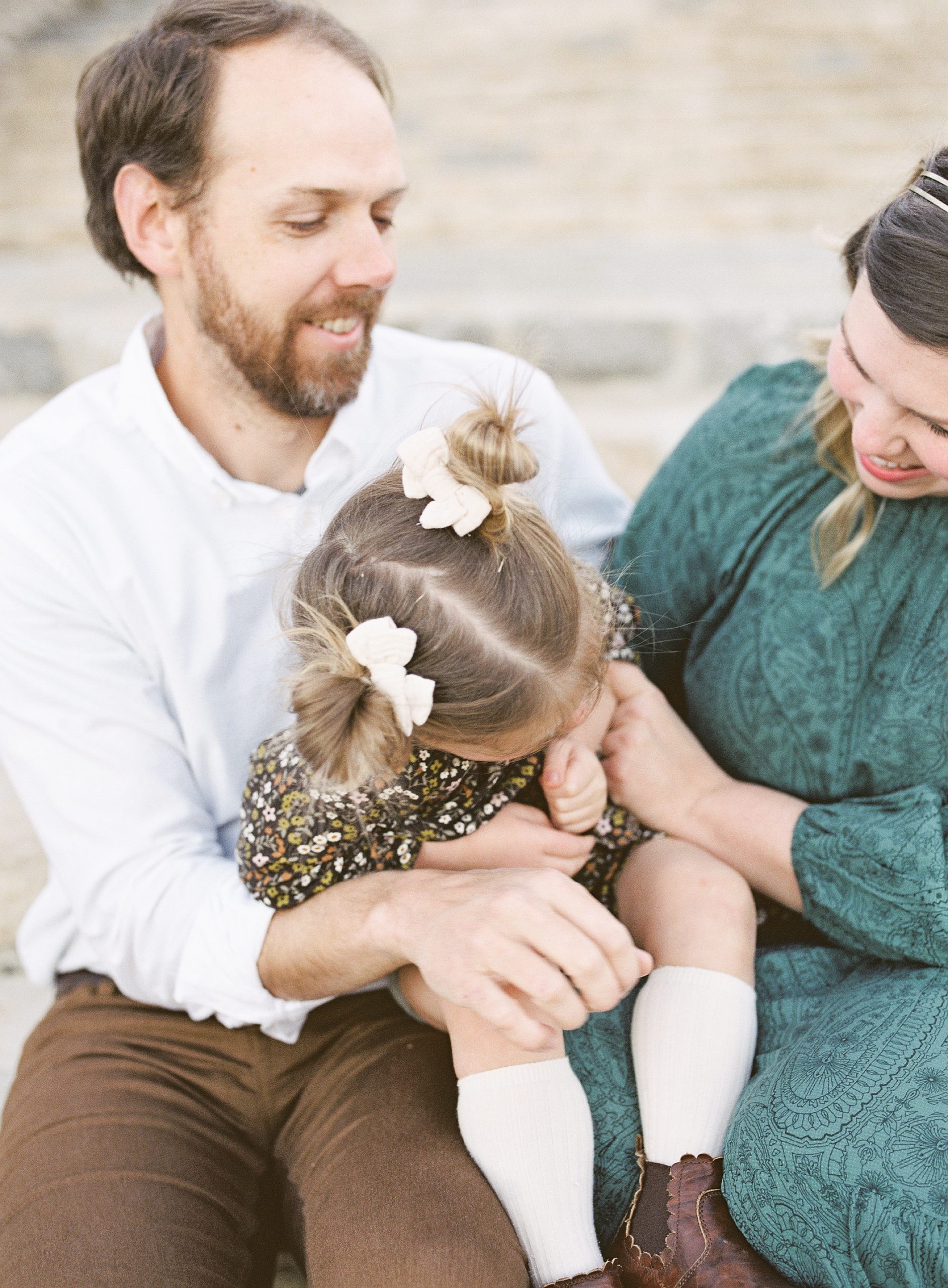 parents tickle toddler during TN family photos