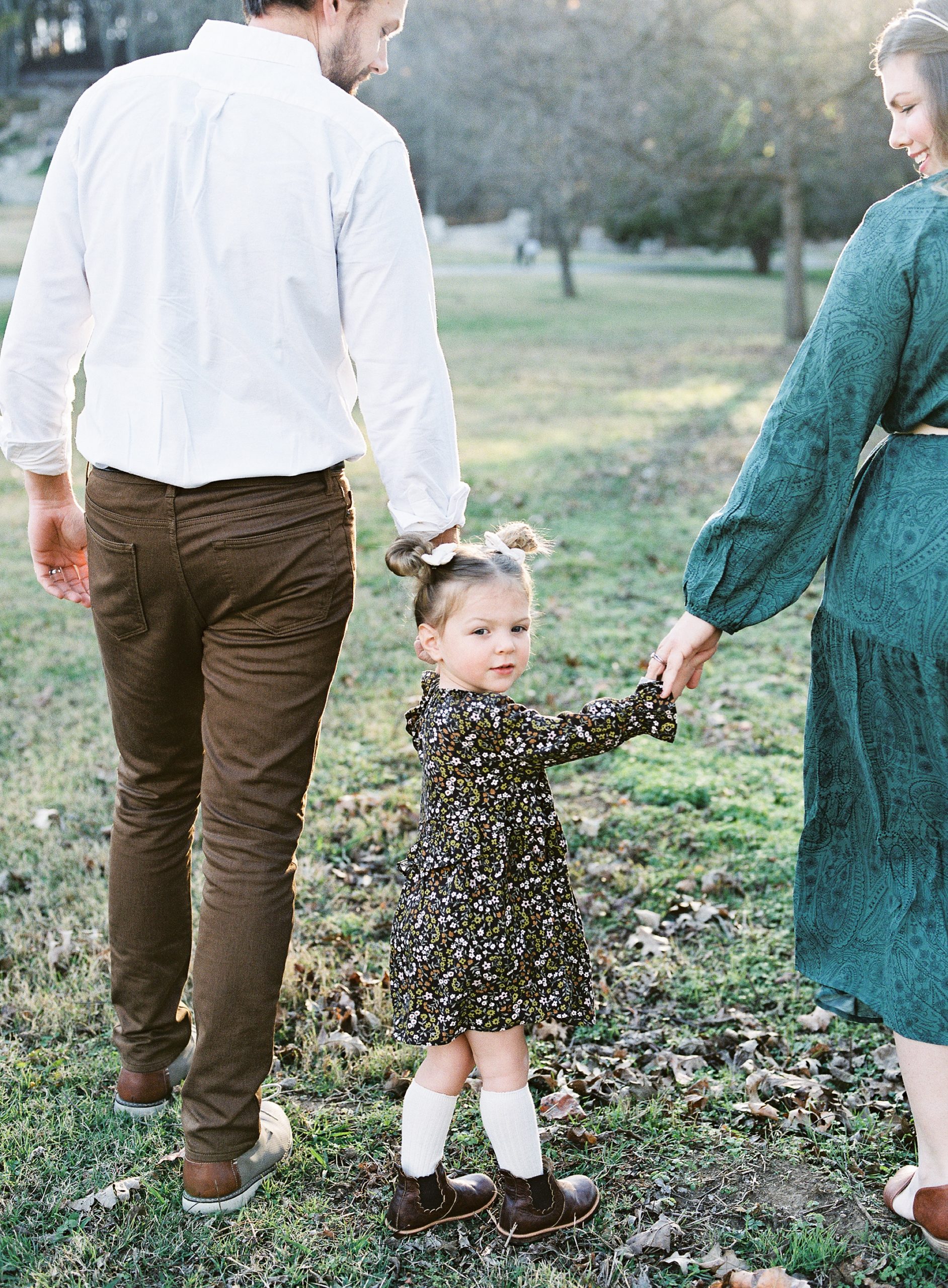toddler looks over shoulder during family photos