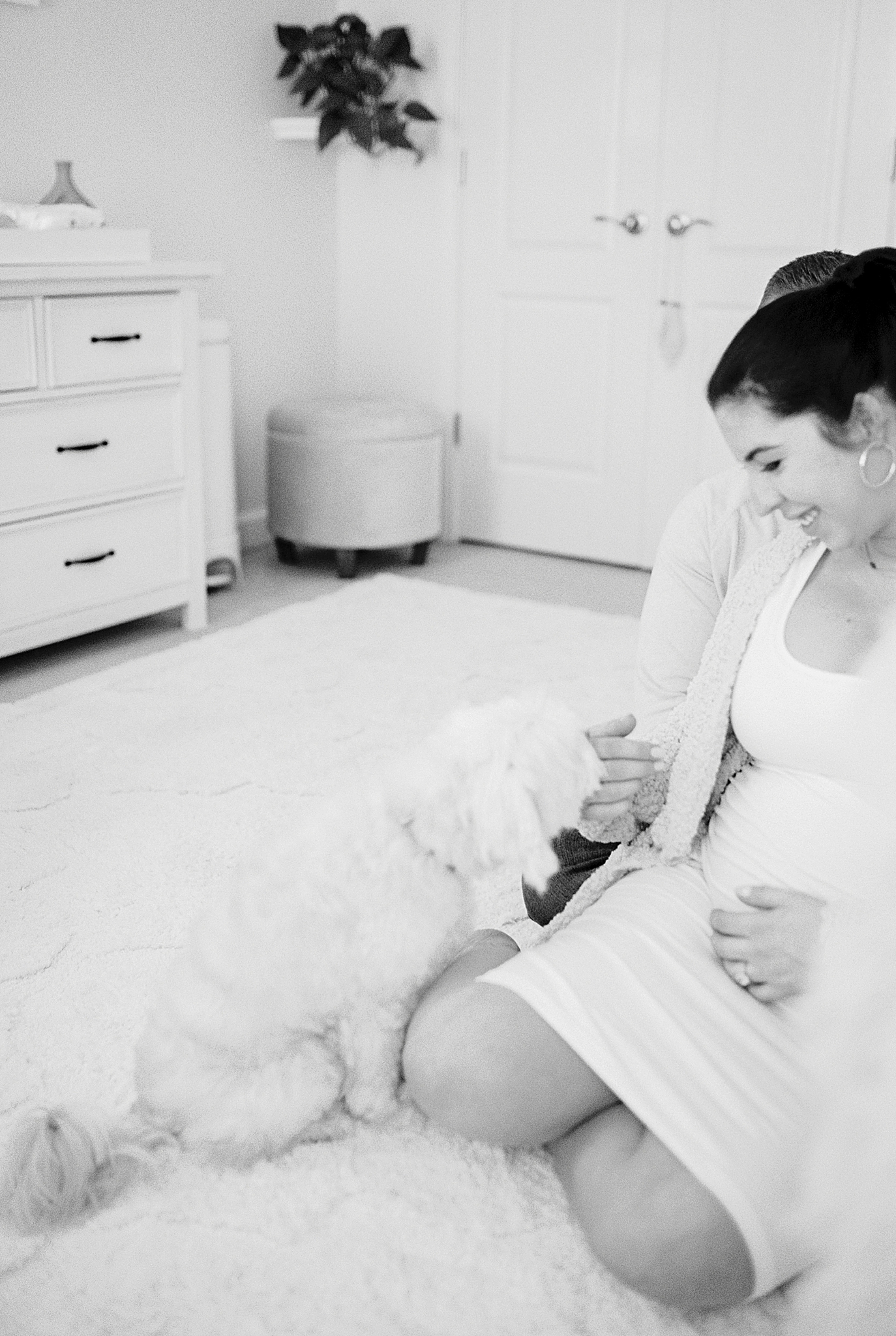 mom pets dog in nursery during TN maternity photos