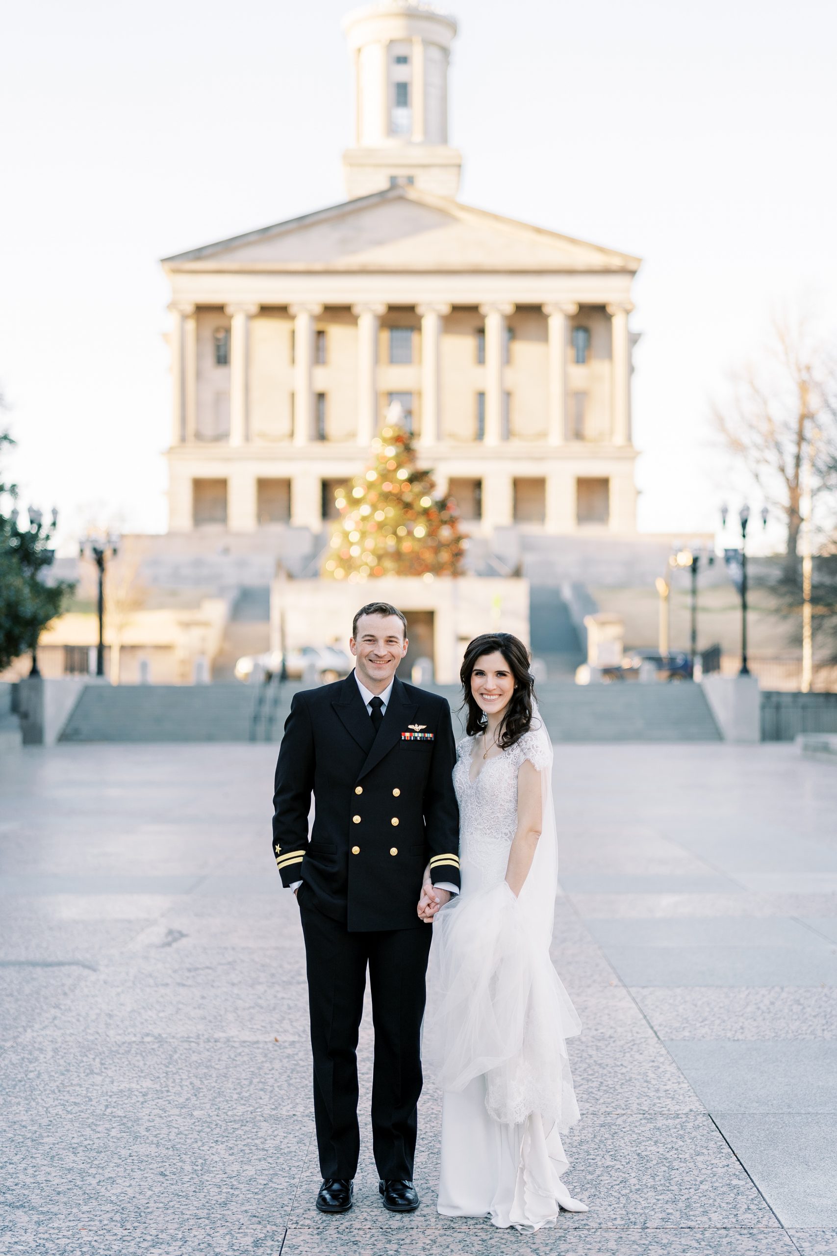 bride and groom pose outside downtown Nashville building