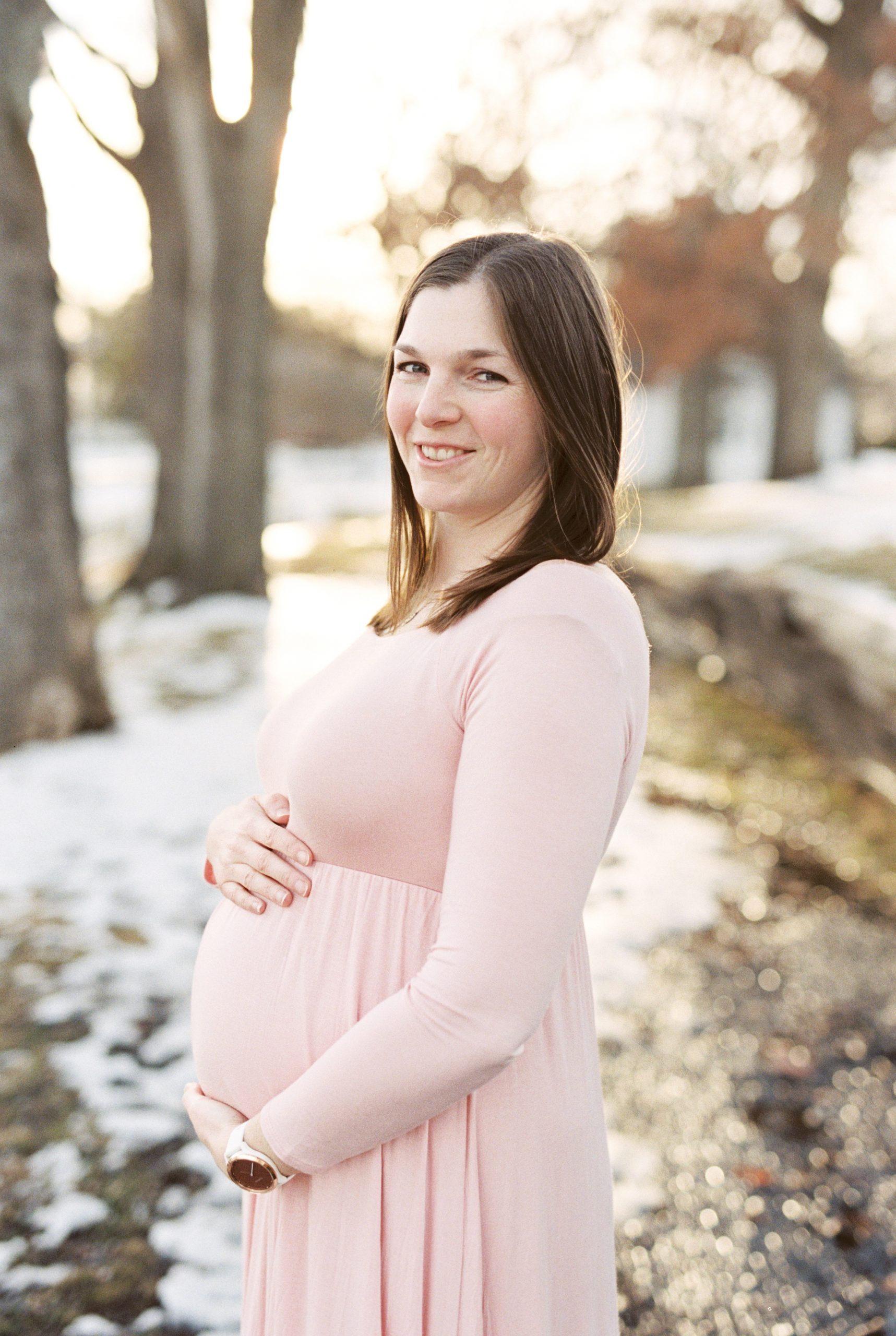 Nashville maternity photographer captures mom in pink dress during winter maternity session