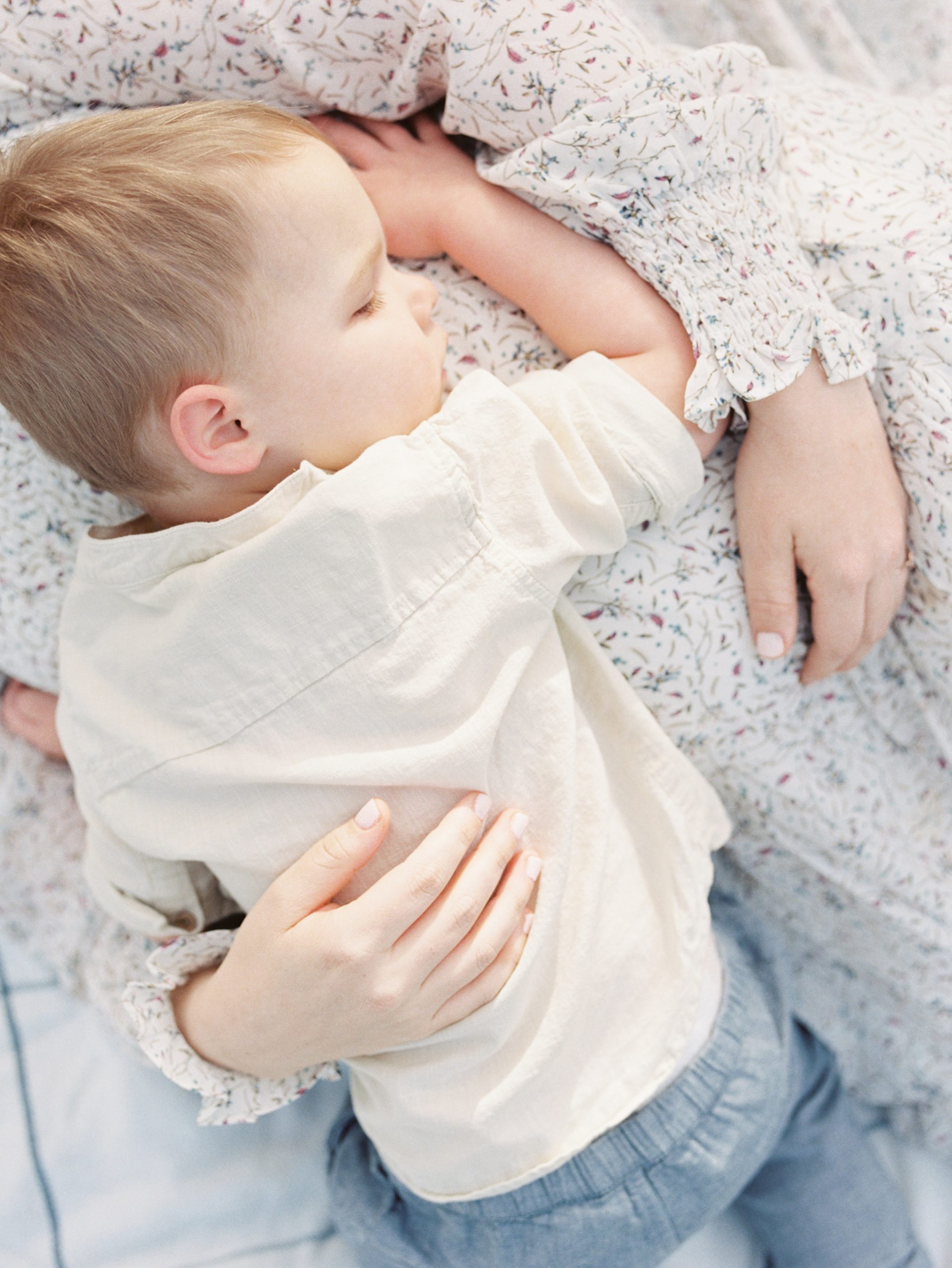 toddler lays on mom's belly during Nashville TN maternity photos