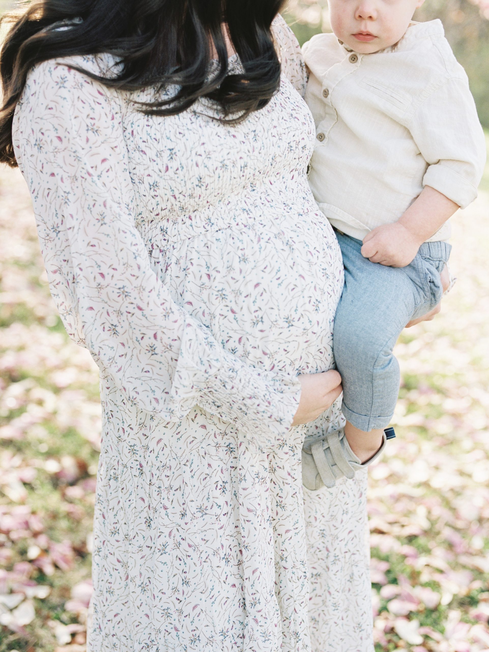 mom holds toddler during Ellington Agricultural Center maternity portraits