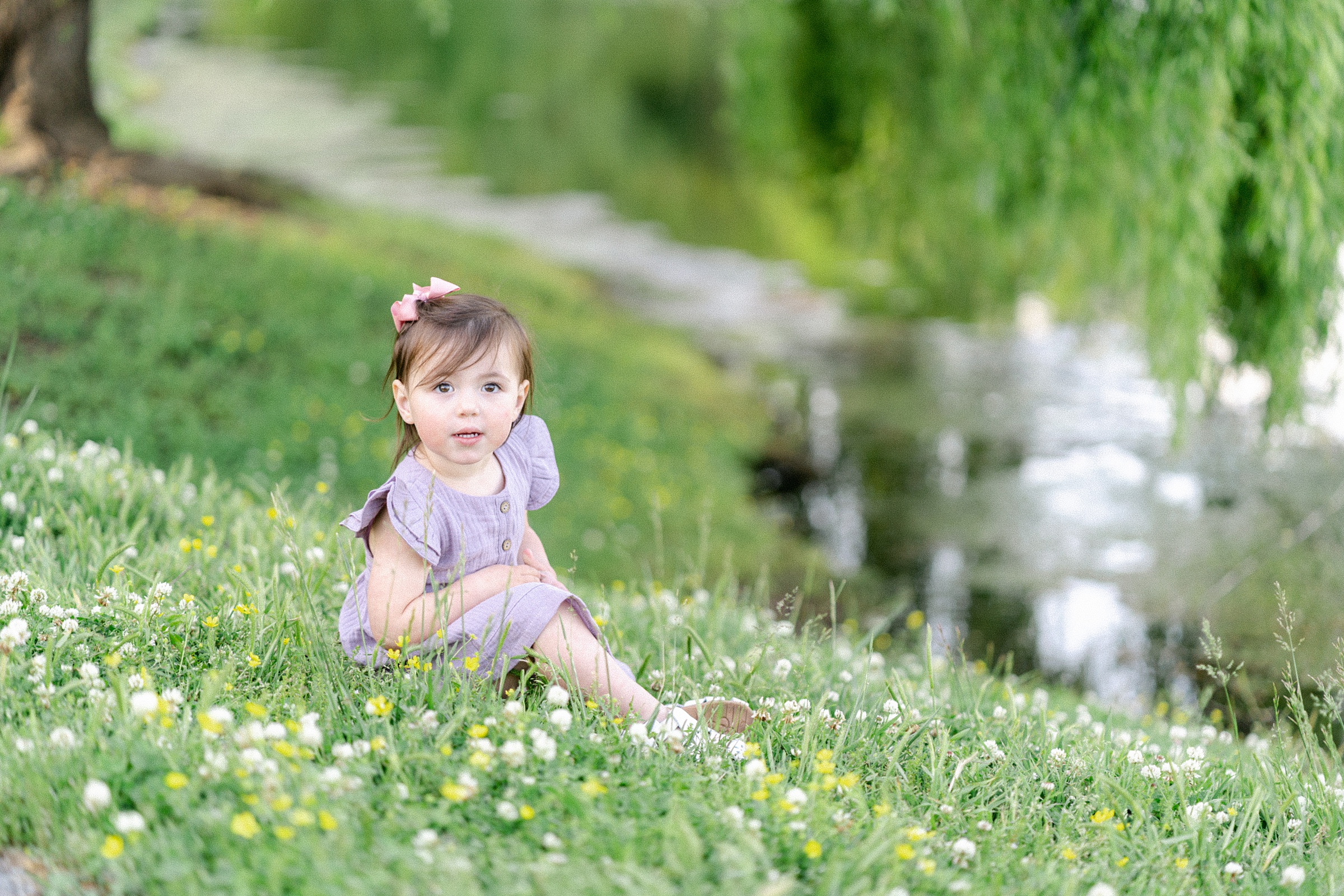 daughter sits by pond during Nashville family session