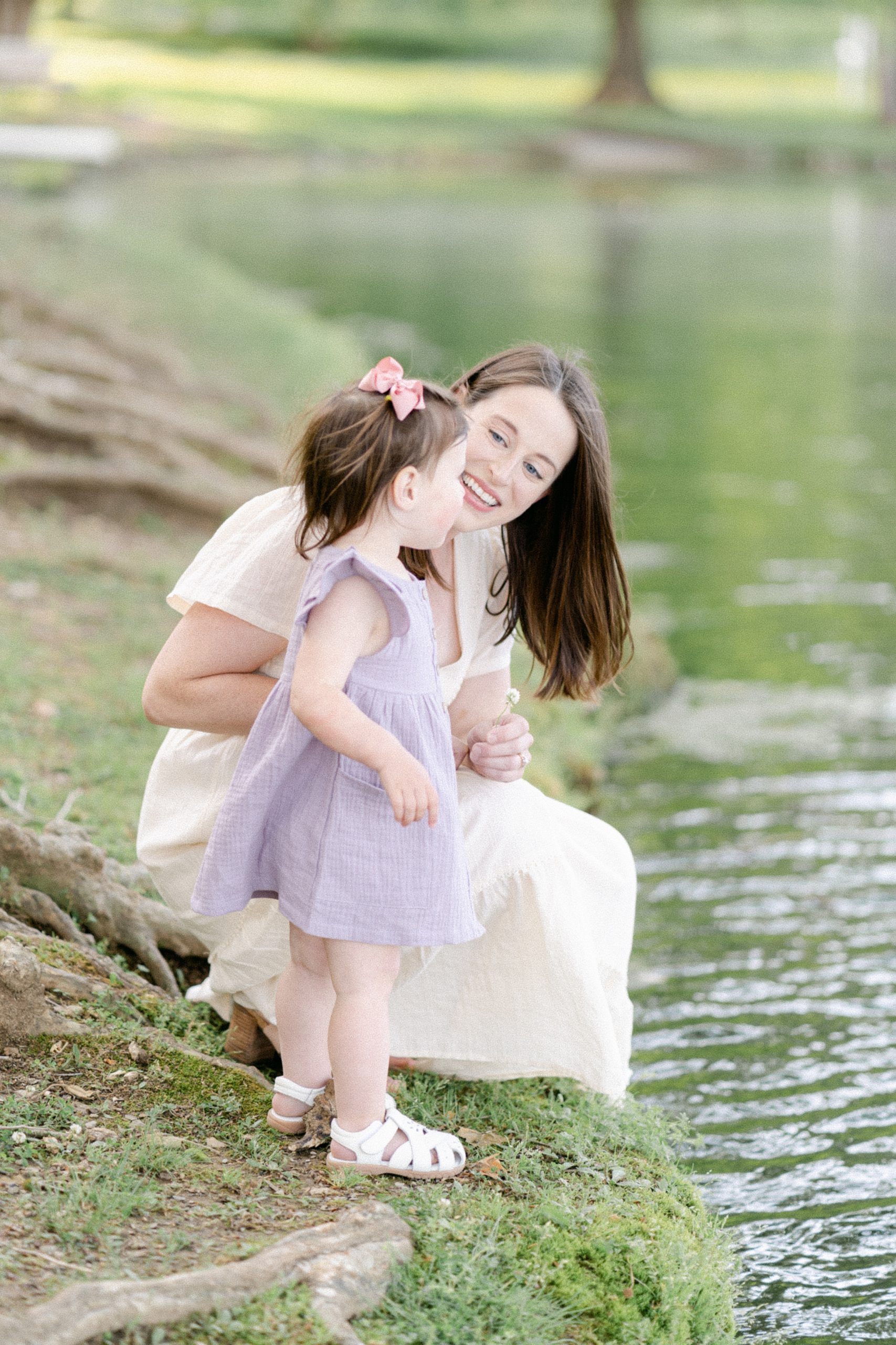 Mom and daughter kneel next to pond for TN family photos