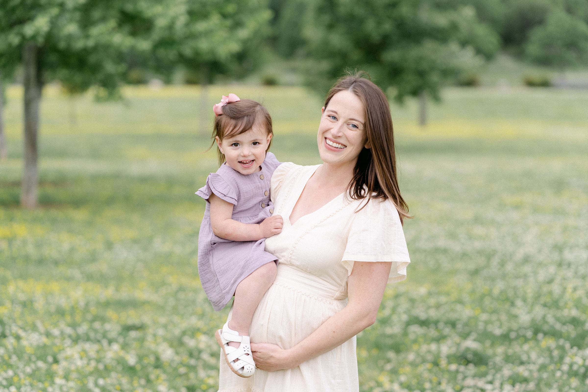 mom holds daughter during Nashville family + maternity portraits