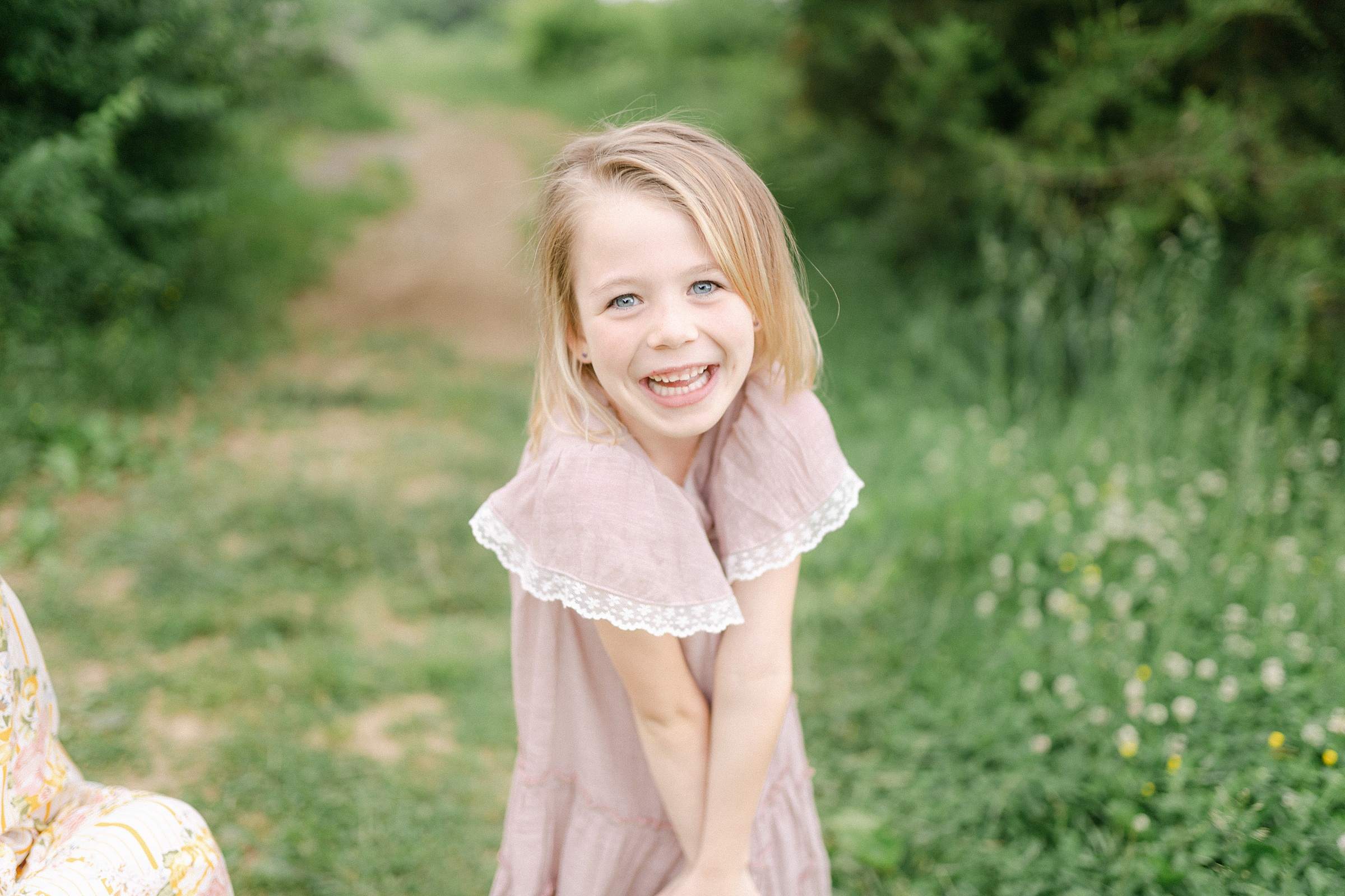 little girl smiles sweetly at camera during Brentwood Family Mini Session