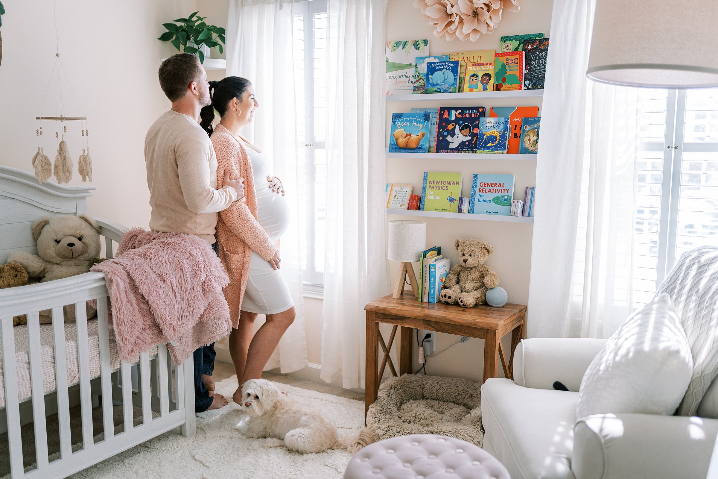 maternity portrait of mom and dad standing in Light + Airy Baby Girl Nursery in Murfreesboro TN