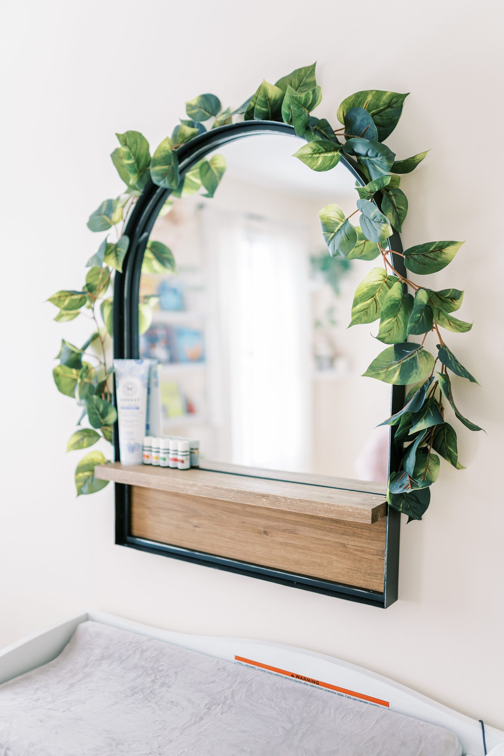 nursery decor-wall mounted mirror wrapped in green vine