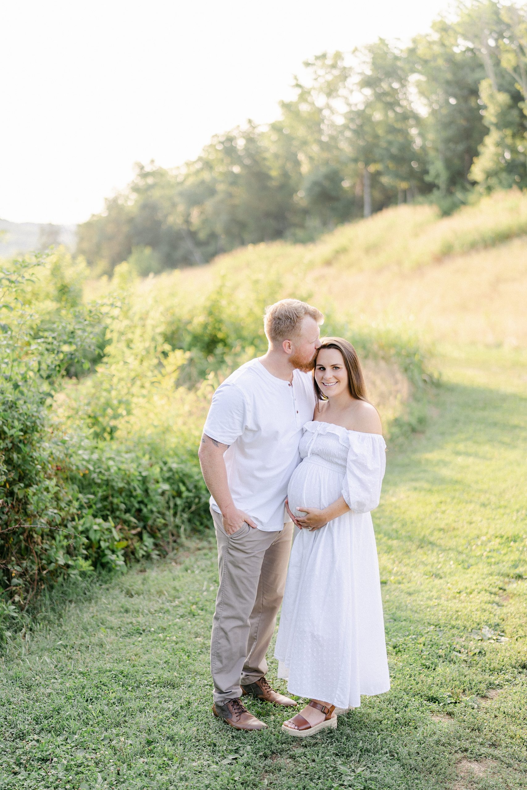 Couple in grass field during Brentwood, TN Maternity Session photographed by Grace Paul Photography
