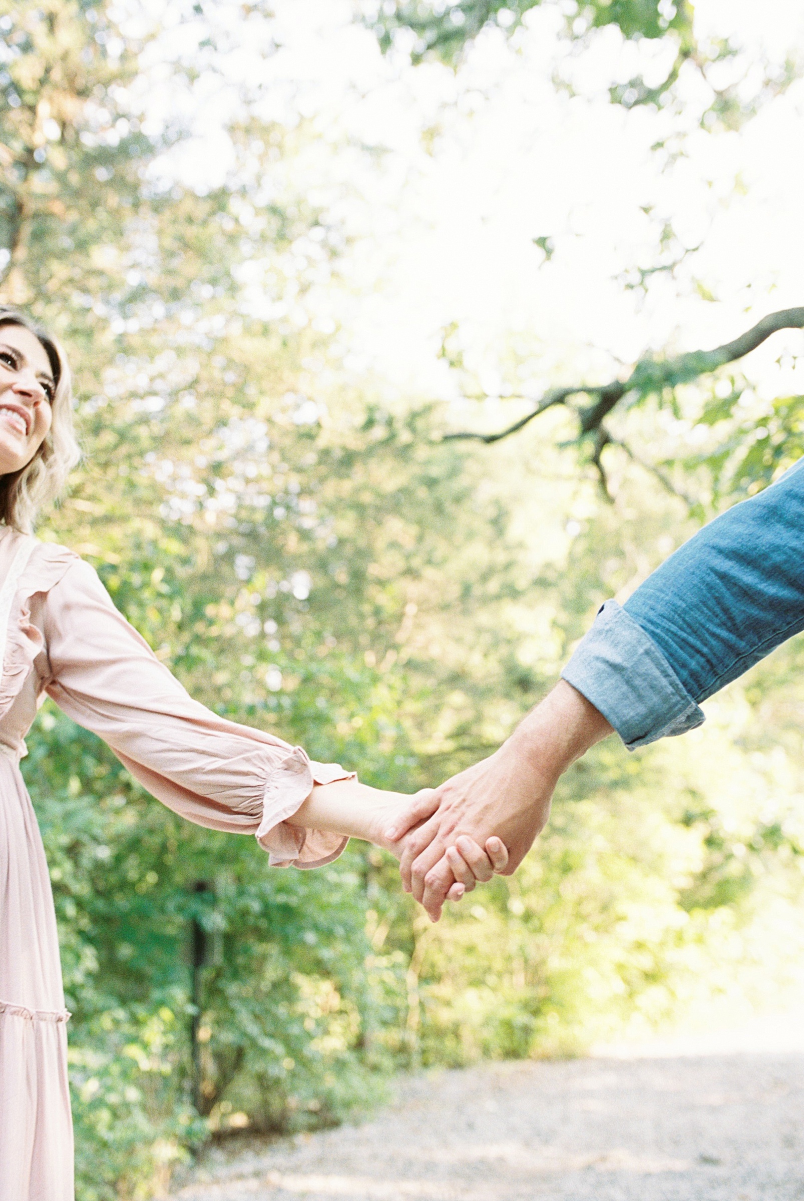 couple holds hands during TX Maternity session in Nashville TN by Grace Paul Photography
