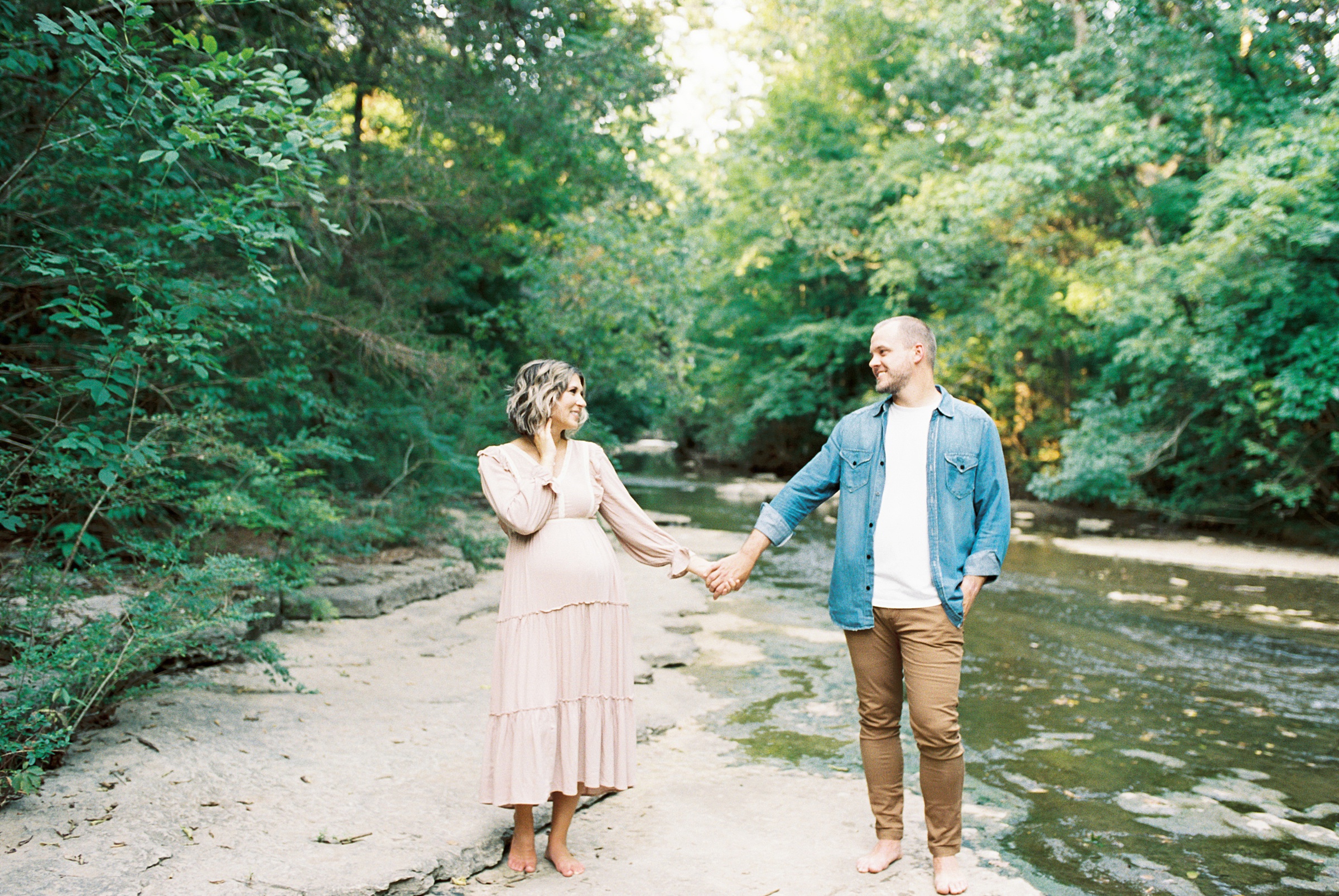 parents to be holding hands in Nashville TN during MAternity session