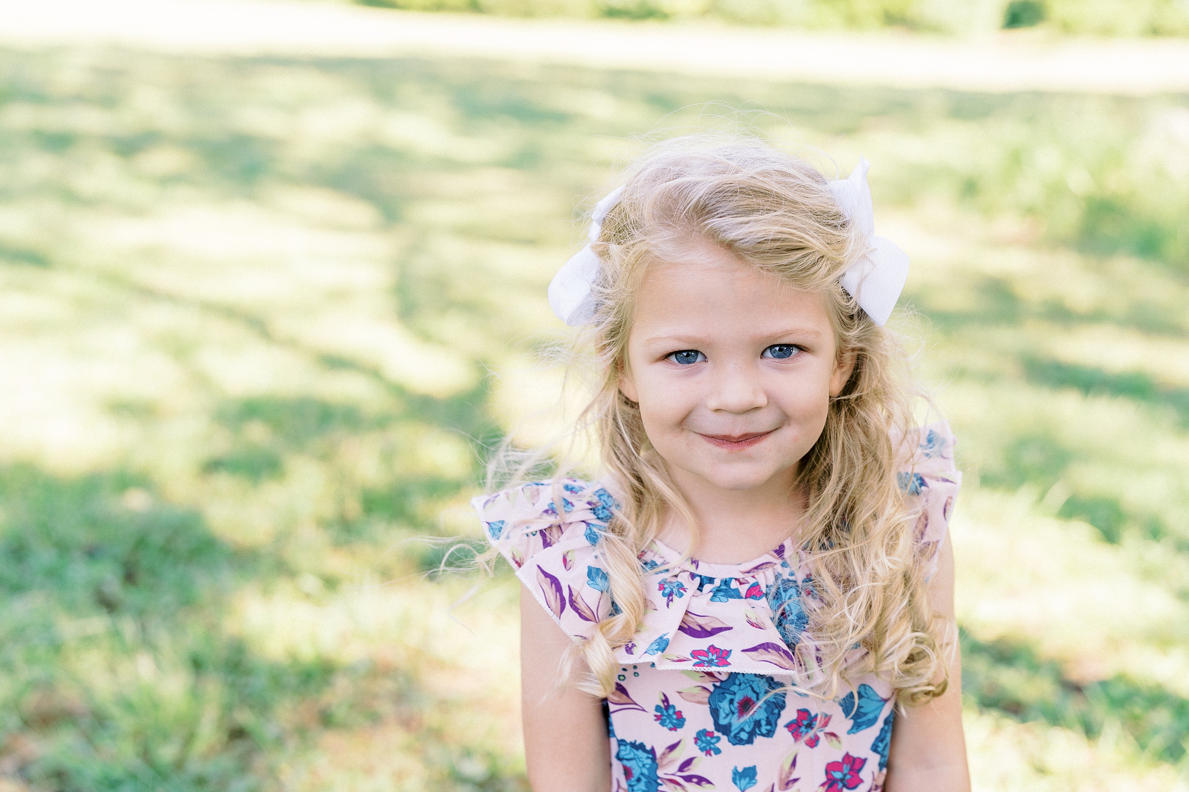 little girl in flower dress during family photos