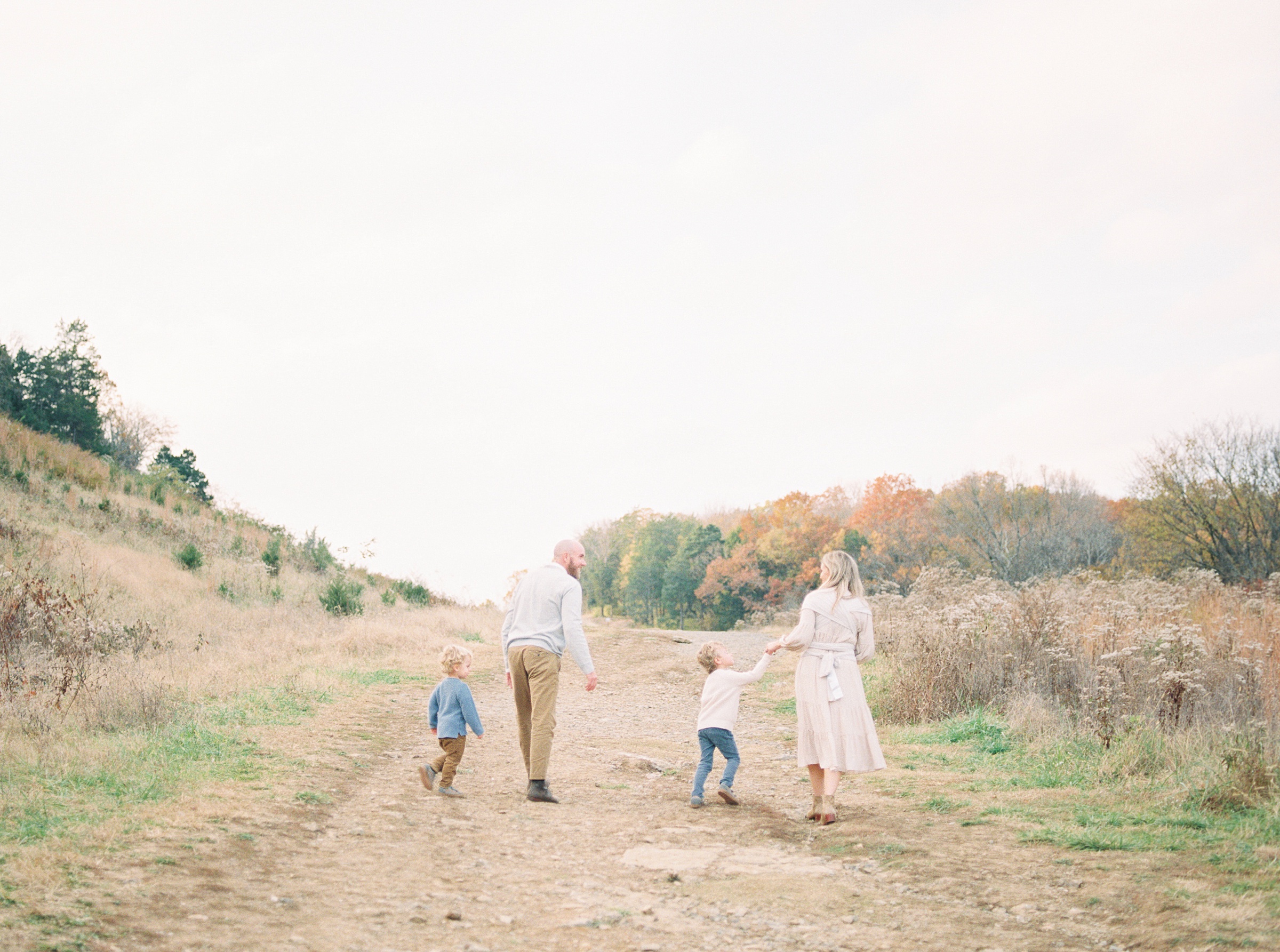 family of five walking down path in Brentwood TN during Outdoor Newborn + Family Session
