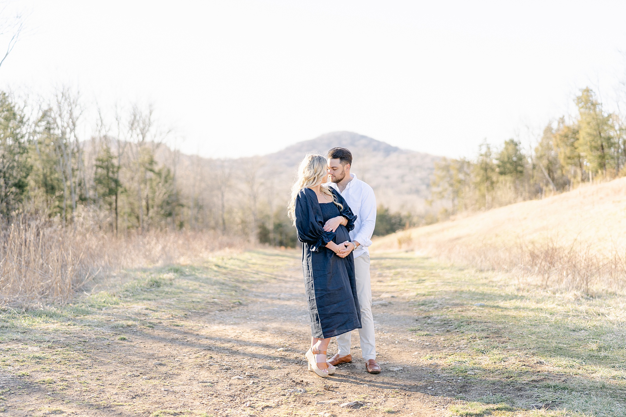 parents stand with mountains in the background during Brentwood TN Maternity session